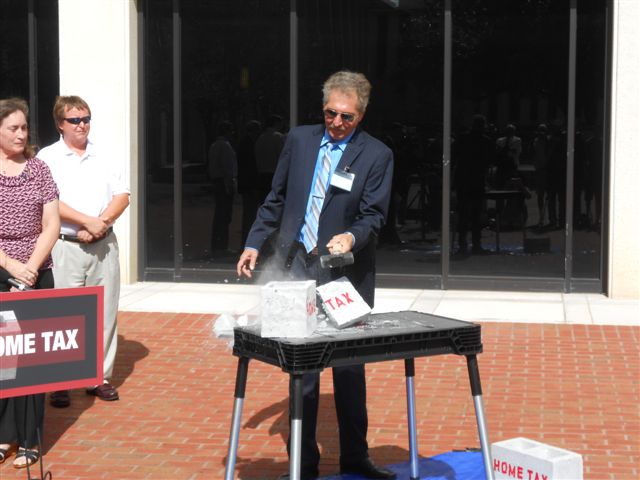 SCCA President symbolically smashes the tax.